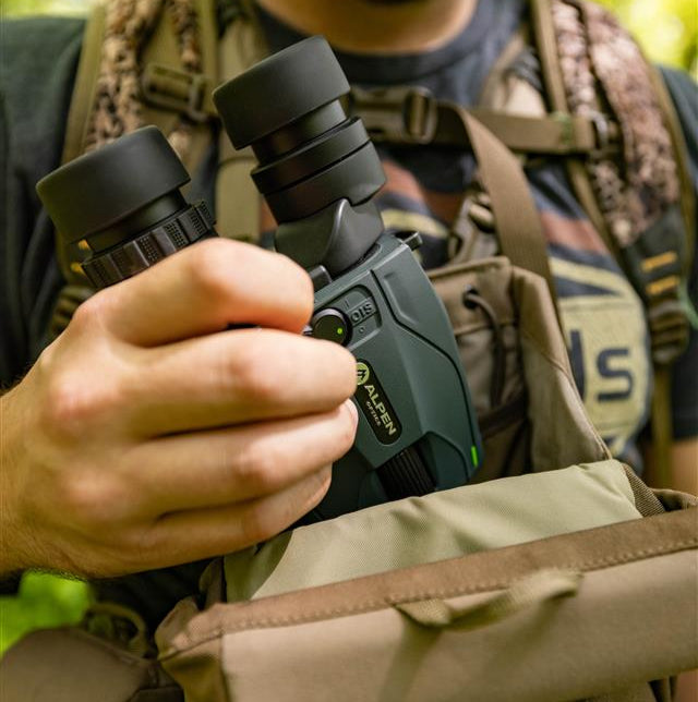 Person holding Alpen Apex Steady image stabilizing binoculars